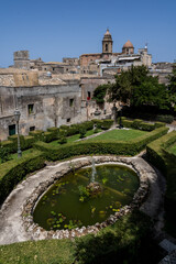 Fountain garden with view of historic town and towers in Erice, Sicily