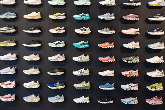 Running shoes grouped by brand, style on display at high-end, boutique-style store, lightweight training, road racing by HOKA, New Balance, Brooks, ASICS, Saucony, ON