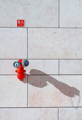 Red fire hydrant on the Champalimaud Foundation building in Lisbon, Portugal. Art, minimalism