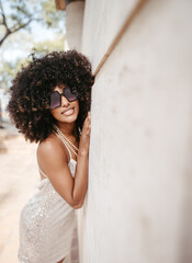 Portrait of a woman with afro hair and sunglasses smiling and happy - Modern fashion and style concept.
