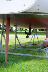 The lower part of the hull of a sailing yacht, which is located on anchor blocks on land during...