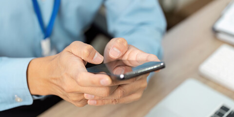 Businessman using smartphone for communication at work