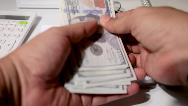 A student reveals a stack of cash prepared for tuition or school costs, with a white envelope marked "Education" placed neatly on a study desk &mdash; representing budgeting, savings, and financial planning