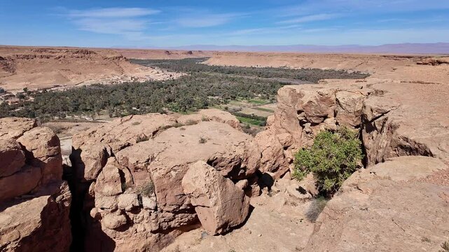 Ziz canyon, Morocco: Panorama of the dramatic Ziz canyon with a palm tree plantation and ancient village in the Atlas mountain on the road between Merzouga and Fes in Morocco