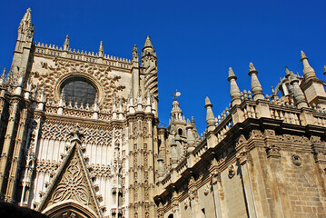 Details of the Gothic style architecture on the fa&ccedil;ade of the Cathedral of Seville. The cathedral of Seville is a huge and imposing building, very rich architecturally