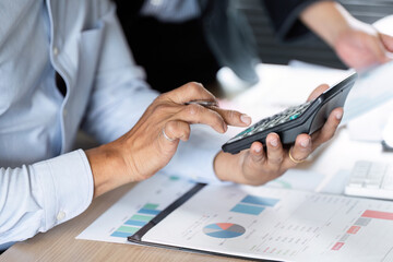 Fototapeta premium Financial Calculation and Data Management. Professional using a calculator for financial analysis.
