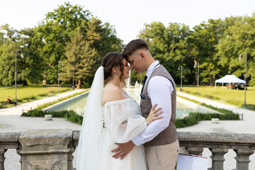 Bride and groom standing opposite each other with their heads nestled together. A couple in love...