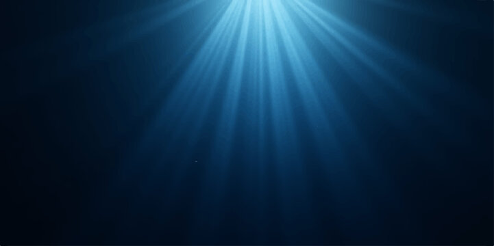 Abstract blue light rays create a dark underwater motion texture background with a deep ocean blur and shine pattern