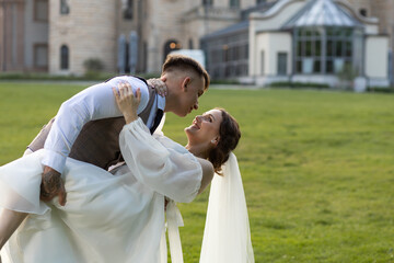 A guy and a girl are dancing at their wedding against the backdrop of a beautiful castle. An...