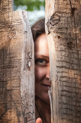 Girl with beautiful eyes near a wooden fence