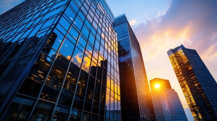 Fototapeta premium Low-angle view of modern skyscrapers at sunset