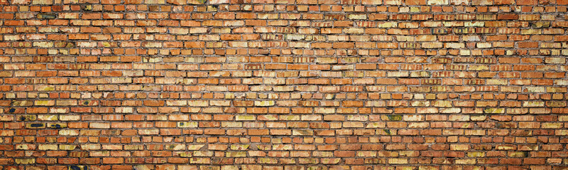 old brick wall of an ancient building. red masonry of stone blocks as background