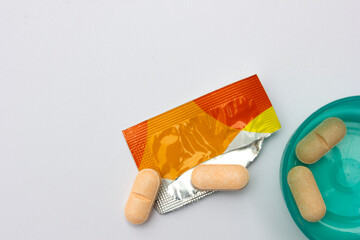 Some of the vitamin C tablets are in tosca green plastic containers. These vitamins have just been moved from their original packaging. Vitamin C is involved in many parts of the immune system.