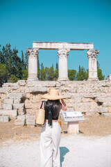 Tourist visiting ancient Corinth archaeological site in sunny Greece