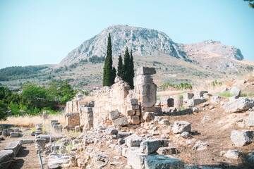 Historic mountain view over ancient Corinthian ruins with pine trees