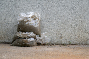 A pile of bags filled with cement and sand.