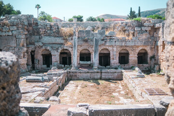Interior of ancient Corinthian structure with columns and arches