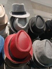 various kinds of cowboy hats in red and black colors sold in the market