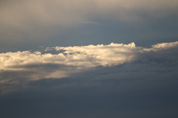 Cloudscape Serenity: A tranquil cloudscape captures the ephemeral beauty of nature's artistry, with sunlight illuminating the soft, textured forms against a backdrop of serene sky.