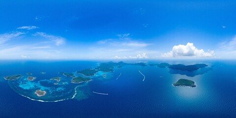 Fototapeta premium Aerial view from height of ocean with islands under a sunny sky - Equirectangular 360 degree landscape
