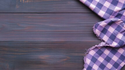 Obraz premium Purple checkered cloth on a dark wooden table with rustic charm
