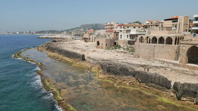 Captivating drone footage of the Phoenician wall, an ancient protective structure located on Mediterranean coast in Batroun, Lebanon