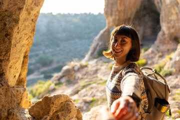 follow me. happy couple traveling. portrait of happy female tourist in mountains. girl smiling. trekking and hiking. girl with backpack.
