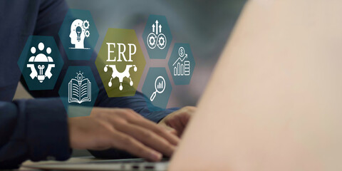 A young person using laptop with ERP Enterprise Resource Planning System Concept on visual screen.