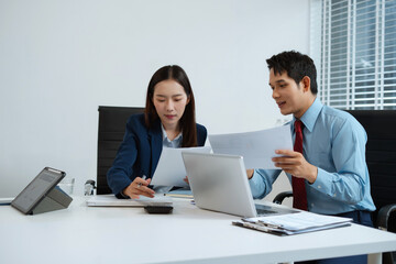 Fototapeta premium Business consultants discuss tax, merger strategy and restructuring in modern office.