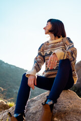 happy woman with backpack in mountains. girl smiles. trekking and hiking. Concept of sport and healthy lifestyle.