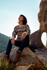 happy woman with backpack in mountains. girl smiles. trekking and hiking. Concept of sport and healthy lifestyle.