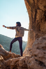 Girl with backpack. Portrait of happy female tourist in mountains. Trekking and hiking.