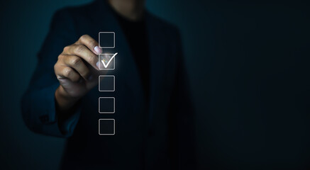 Businessman checklist concept as clipboard document checklist form on the virtual screen Use your hands or a pen to check the correct control gaps and check the quality standards of the work.
