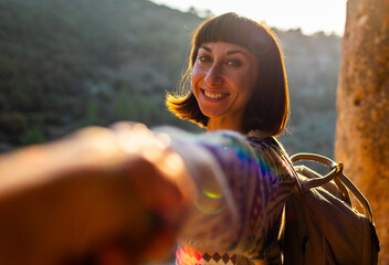 follow me. happy couple traveling. portrait of happy female tourist in mountains. girl smiling. trekking and hiking. girl with backpack.