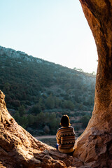 Woman in the mountains. Girl traveling in the mountains. Trekking and hiking. Girl with a backpack.
