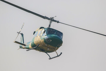 bell 212 rescue helicopter in flight with camouflage colours