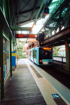 Wuppertal, Germany,  June 8 2025. Modern suspension monorail train arriving at platform in Wuppertal, Germany. Urban transport system.