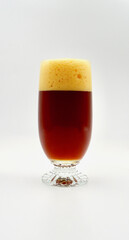 A closeup of a glass of double red ale isolated against a white background.