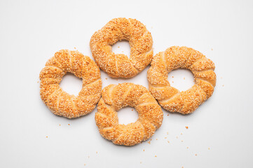 Simit or gevrek, round bagel with sesame seeds on white background top view. Traditional Turkish pastry, Istanbul street food. Delicious fresh homemade pastry, bakery product. Bagel mockup