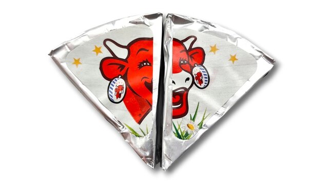 Top view of two foil-wrapped cheese wedges featuring the iconic Laughing Cow logo (La Vache Qui Rit), isolated on a white background.