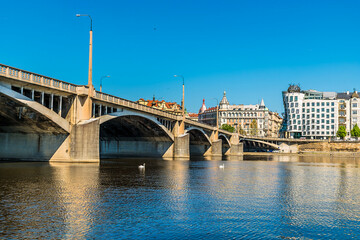 A view from the Vltava river passing under the Jirasek Bridge in Prague in springtime