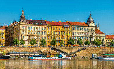 A view from the Vltava river towards the east bank after the Jirasek Bridge in Prague in springtime