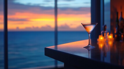 A sleek martini glass on a glossy bar counter, with a breathtaking ocean sunset visible through floor-to-ceiling windows in the background.