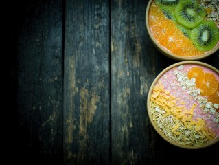Two vibrant smoothie bowls on a dark wooden table