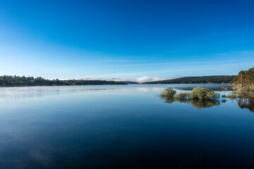 Fototapeta premium Misty Morning on Cuerda del Pozo Reservoir with Bridge, Soria, Castilla y Leon, Spain