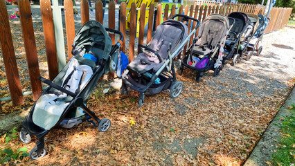 strollers mnay for babies in park waiting