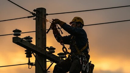 electric lineman working on power lines at sunset with safety gear and tools on utility pole - Powered by Adobe
