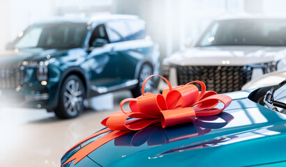 New car purchase at dealership with red bow on suv hood