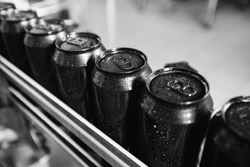 Industrial beer production, cans on assembly line in brewery factory setting top view
