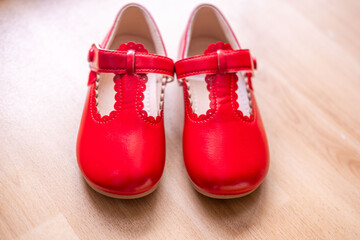new pair patent leather shoes, Little girl excitedly putting on bright red shoes, learning to put on shoes, self dressing skill, Ready for party or special event, Childhood joy